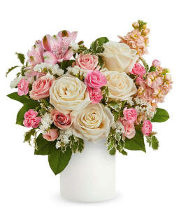 Ivory and blush rose arrangement with pink accents in a modern white vase