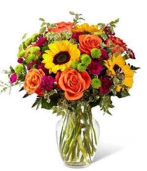 Yellow sunflowers with orange roses and poms