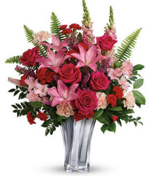 Hot pink roses and pink lilies with snapdragons and carnations in a silver vase, approx 21 inches tall