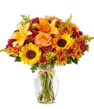 Vase arrangement featuring sunflowers and lilies