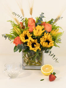 Orange roses, lilies and sunflowers arrangement