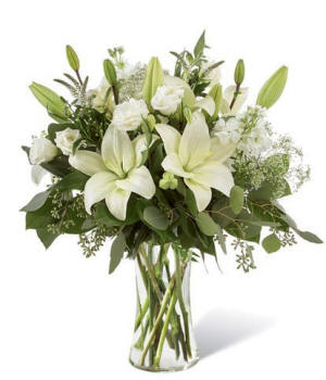 Tall glass vase arrangement of white lilies with roses for an elegant, classic look